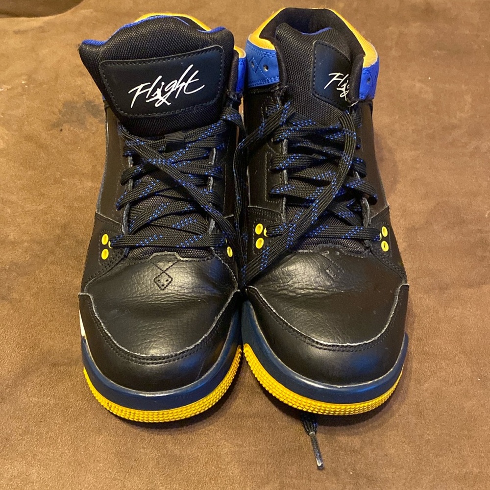 black, blue, and yellow flight jordan’s
